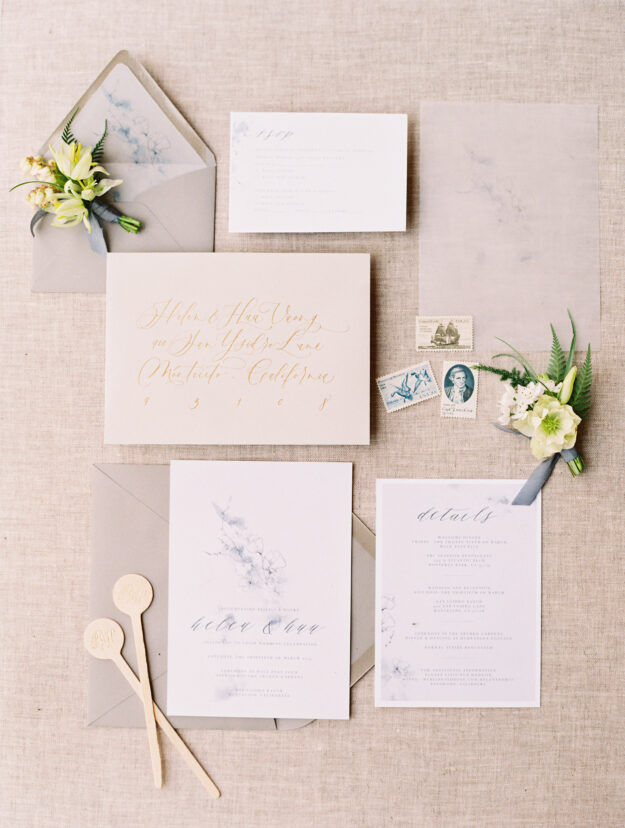blue and linen wedding invitation flay lay